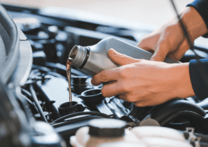 A professional car maintenance personnel changes the car oil for better performance.