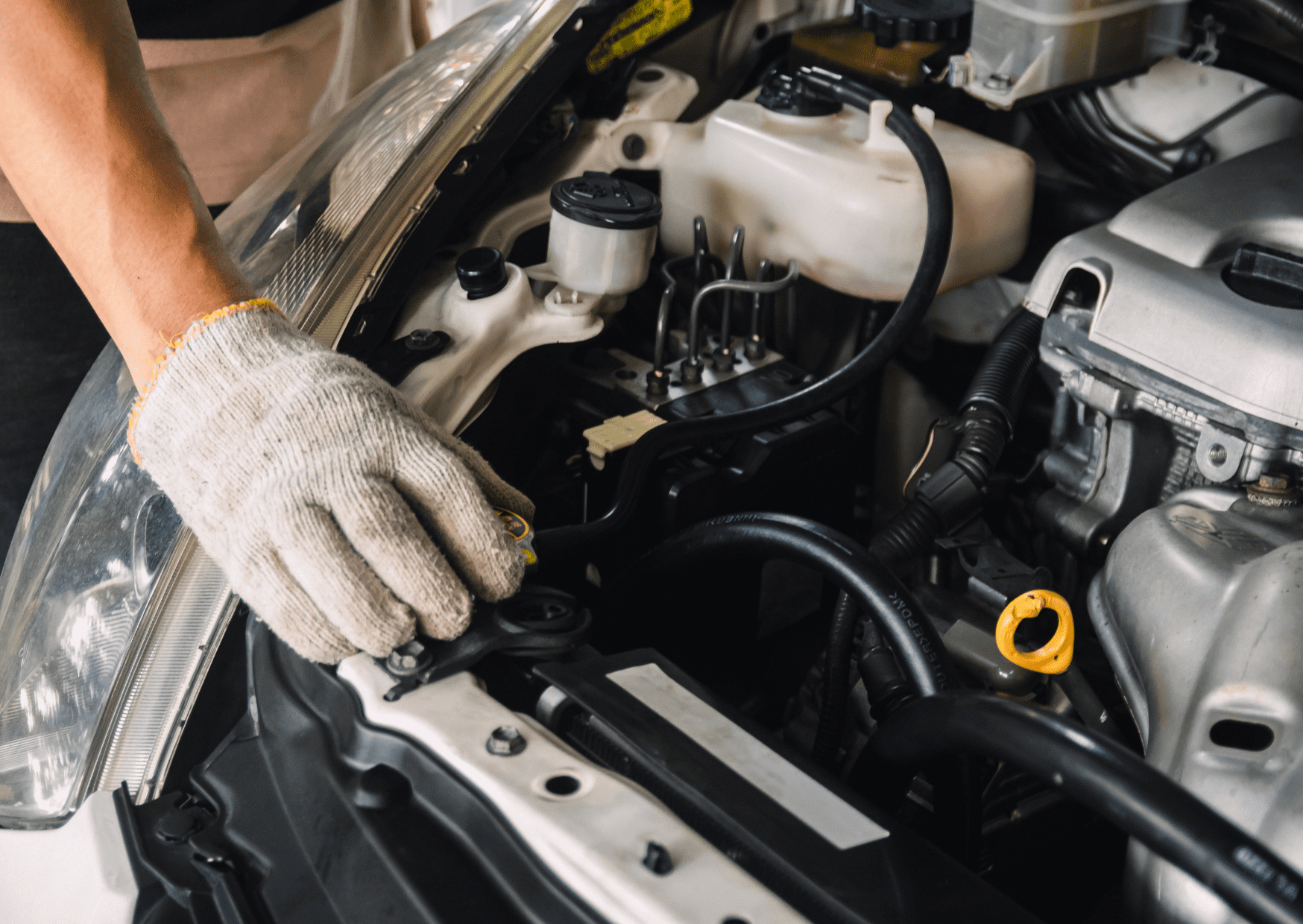 A person checking your engine for a vehicle's safety systems to reduce the risk of accidents.