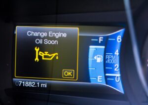 Car dashboard showing "Change Engine Oil Soon" warning. What does the oil change symbol look like? A wrench and oil can icon.