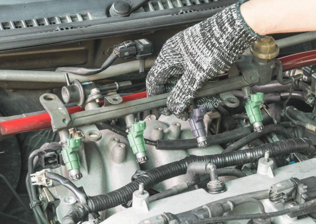 Mechanic removes fuel injectors from the rail. Dirty or faulty injectors cause fuel system problems.