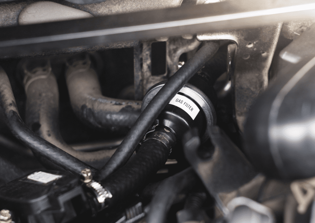Close-up of a gas filter in a car engine. A clogged fuel filter can lead to fuel system problems.