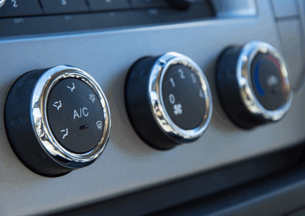 Dashboard knobs showing A/C and fan controls, explaining what is climate control system in car.