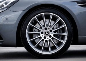 Close-up of Mercedes alloy wheel and perforated brake disc, illustrating EV tire rotation service.