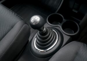 Close-up of a car’s gear shift and console, representing local experts repairing manual transmission and controls.