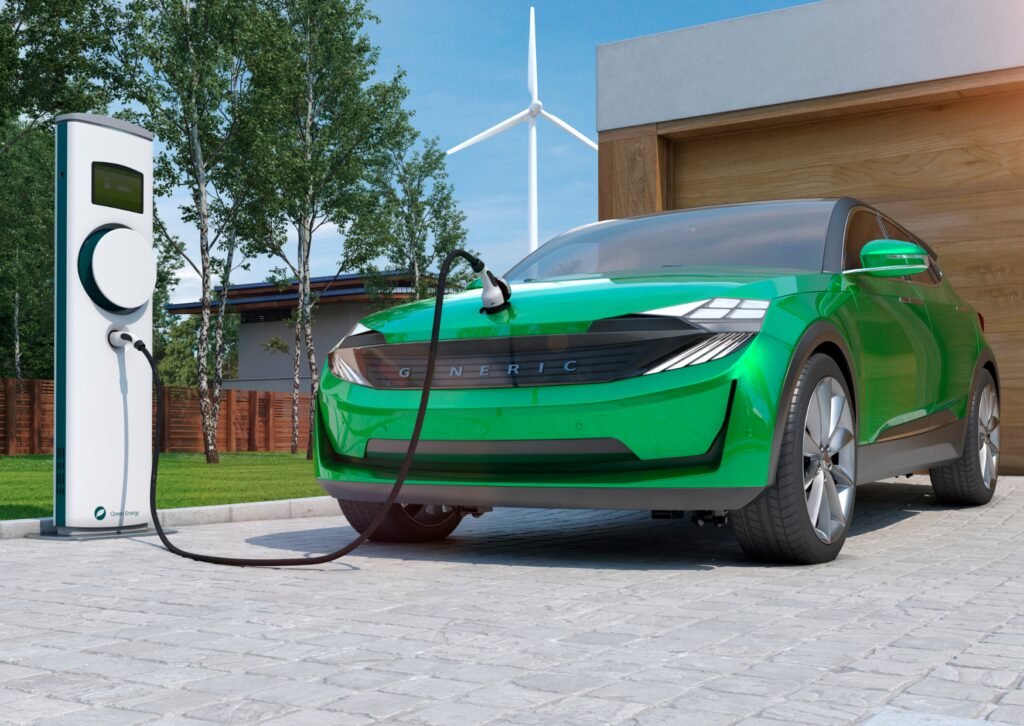 Green electric SUV charging at home station near garage and wind turbine, promoting electric car maintenance tips.