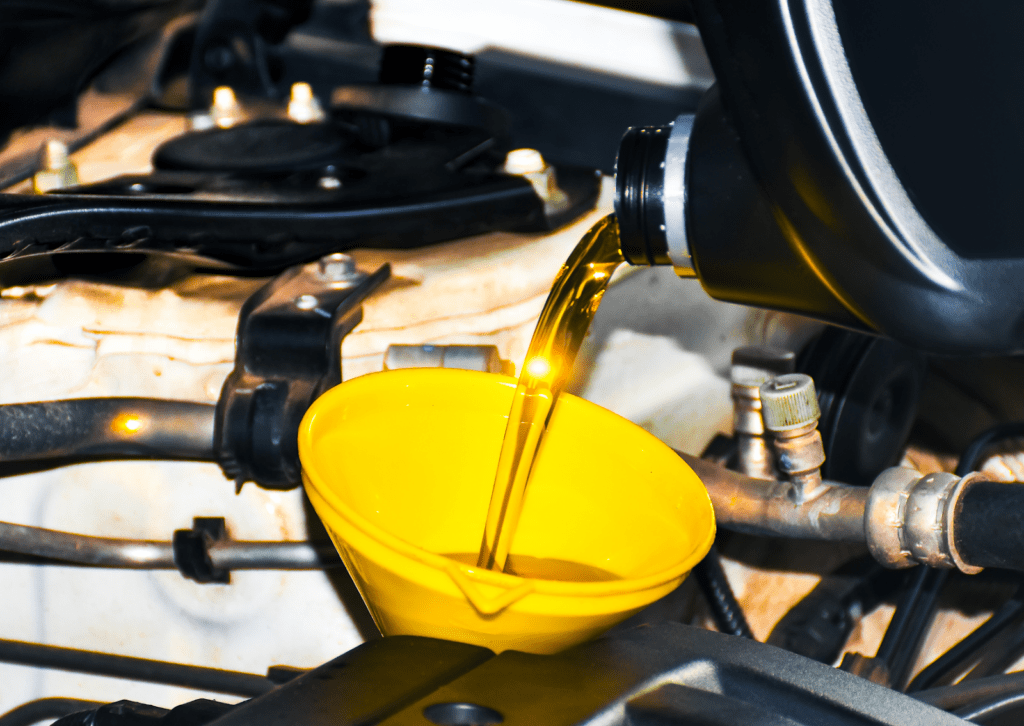 Car dashboard instrument cluster with orange-lit speedometer in km/h, tachometer, fuel and PRNDS gear.