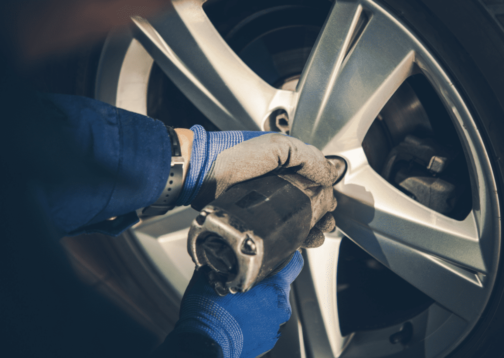 Close-up of plastic brake fluid reservoir with DOT 4 cap, warning icons, and hoses in engine bay for checks.