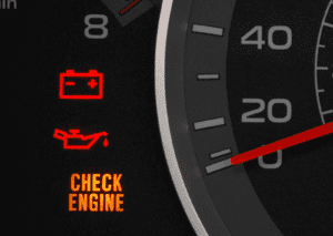 Dashboard gauge shows flashing check engine light with battery and oil warning symbols lit.