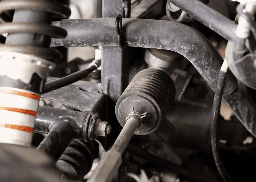 Close-up of steering and suspension components showing parts linked to car suspension noises.
