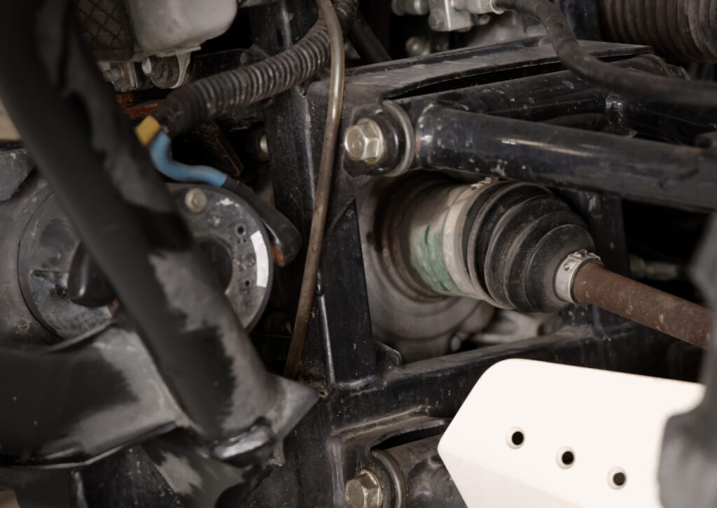 Close-up of vehicle suspension and axle components answering what are the 3 common suspension noises