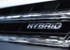 Close-up of hybrid badge on grille for hybrid and luxury vehicle service and diagnostics care 