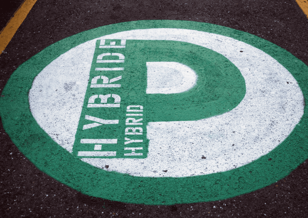 Painted hybrid parking symbol on pavement marking a dedicated space for efficient vehicles 