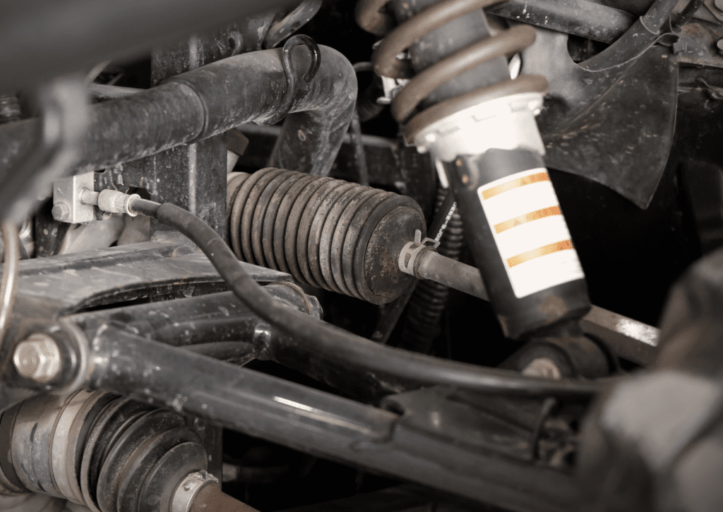 Close-up of worn suspension parts related to suspension-noises-in-car under vehicle chassis 