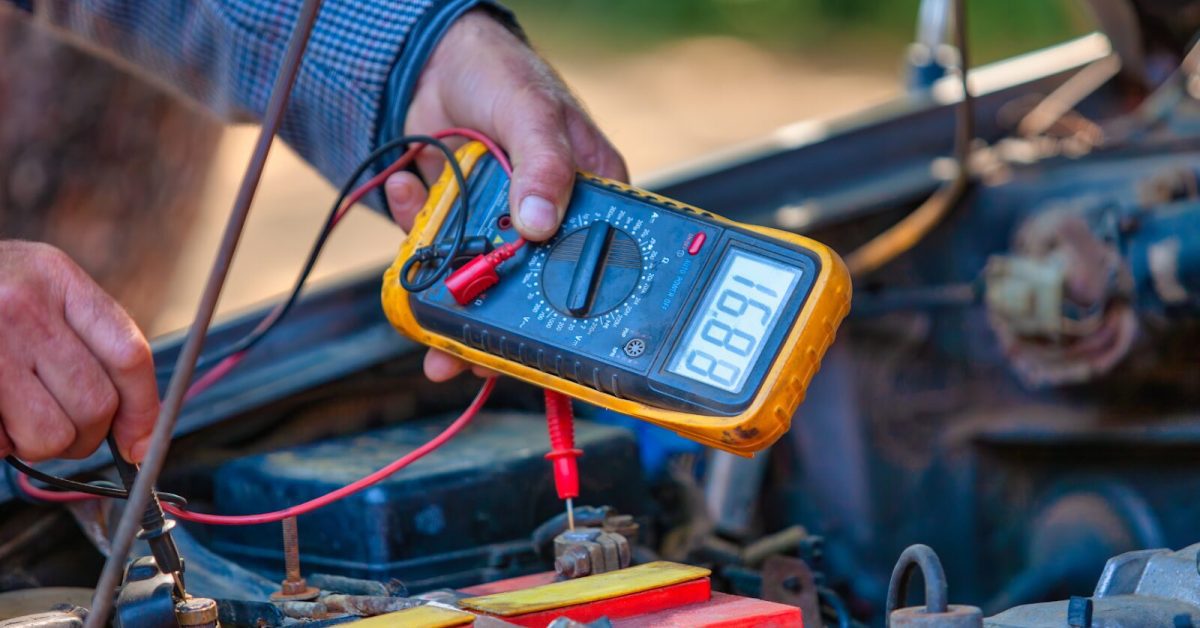Measures the Voltage Technician using a multimeter to test which vehicle instrument measures the voltage in a vehicle’s electrical system.