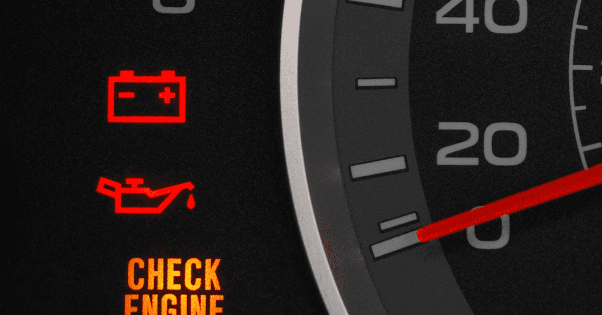 Dashboard gauge shows flashing check engine light with battery and oil warning symbols lit.