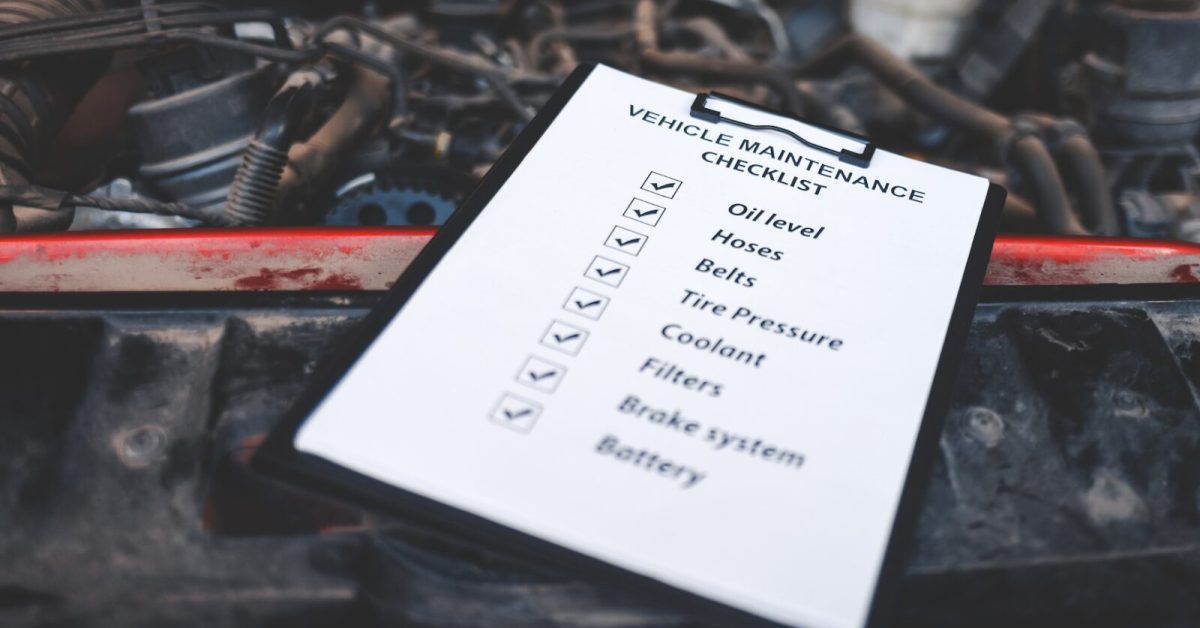Car maintenance checklist on a clipboard resting on an open engine bay, listing essential vehicle service tasks. Car maintenance checklist on a clipboard resting on an open engine bay, listing essential vehicle service tasks.